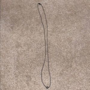 black necklace with dark silver stone